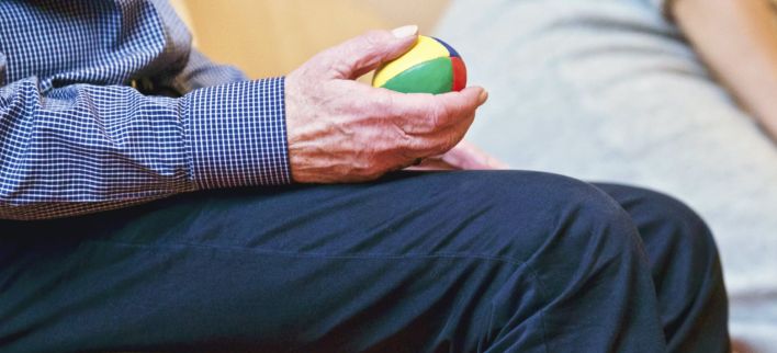 Person Holding Multicolored Ball